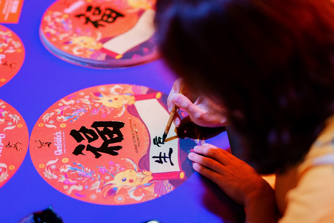 close up of calligrapher personalizing wishes