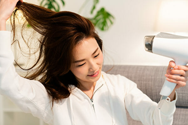 young,attractive,asian,woman,dries,her,hair