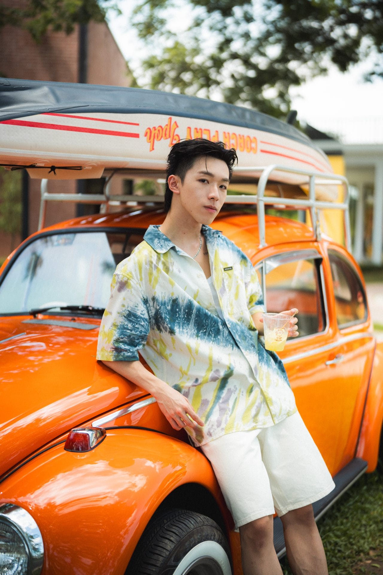 joe shiang posing with the vintage car