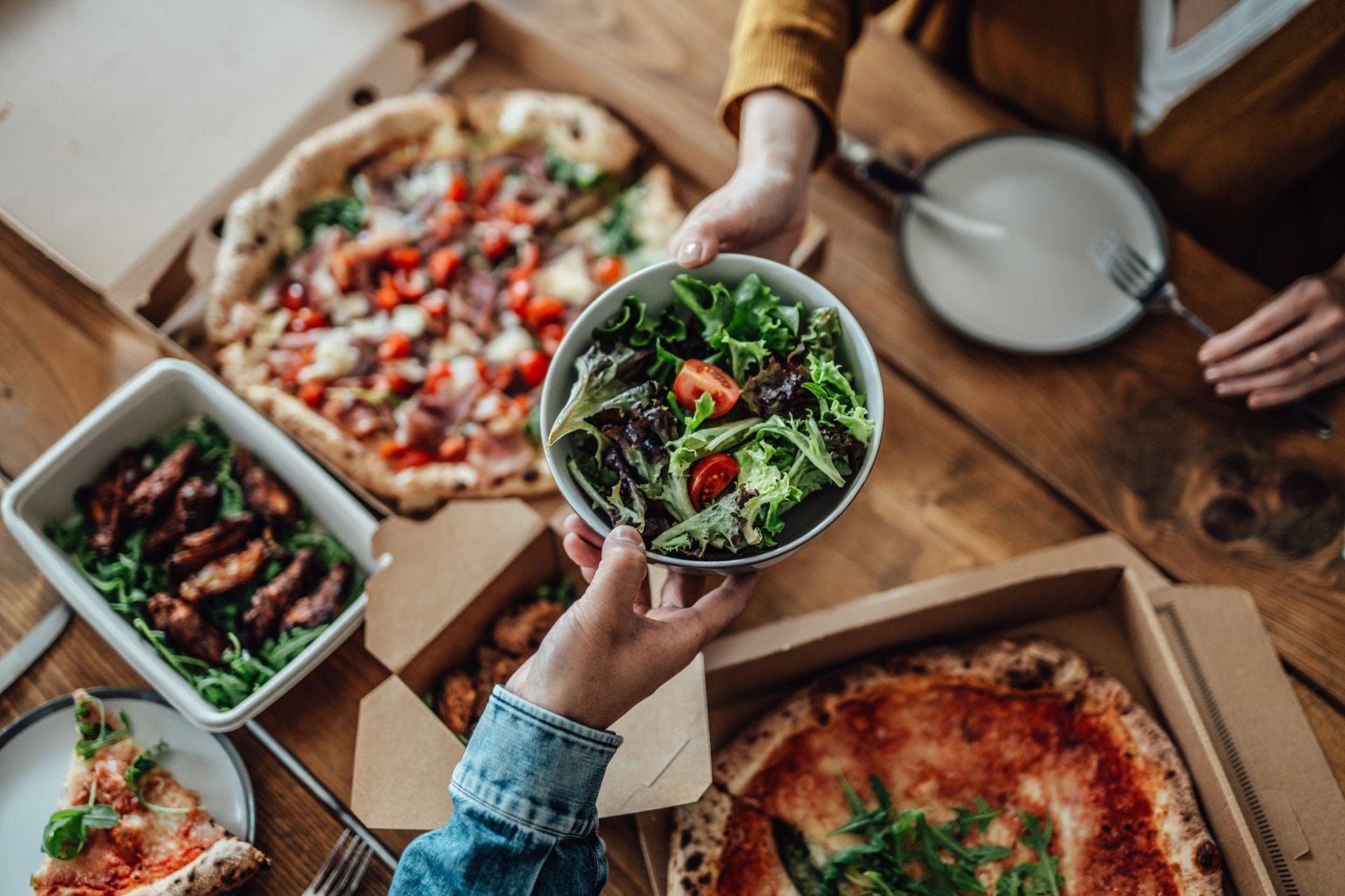 couple sharing takeaway meal at home royalty free image 1671440755